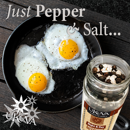 Eggs frying in a skillet with Pepper & Salt