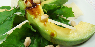Slice of avocado on rocket with Fig Balsamic Vinegar and Pinenuts