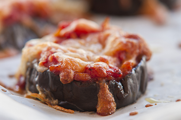 Aubergine with a bubbling grilled cheese topping.